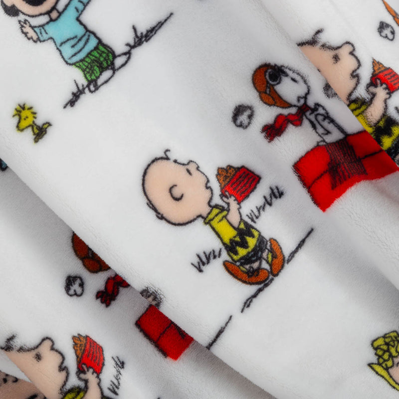 A close up of a white peanuts characters throw displaying its smooth plush texture.