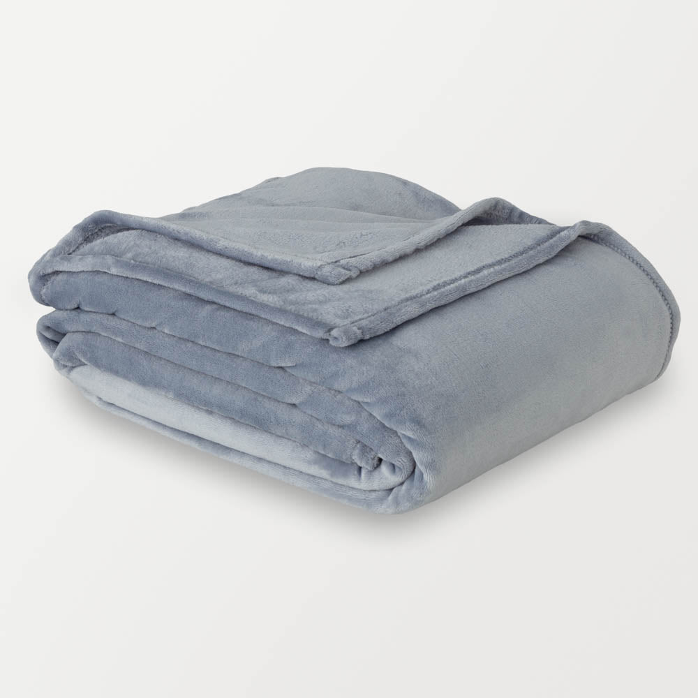 A folded blue velvet blanket displayed on a white background.