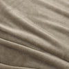 A close-up of a green velvet blanket showing its soft, smooth texture.