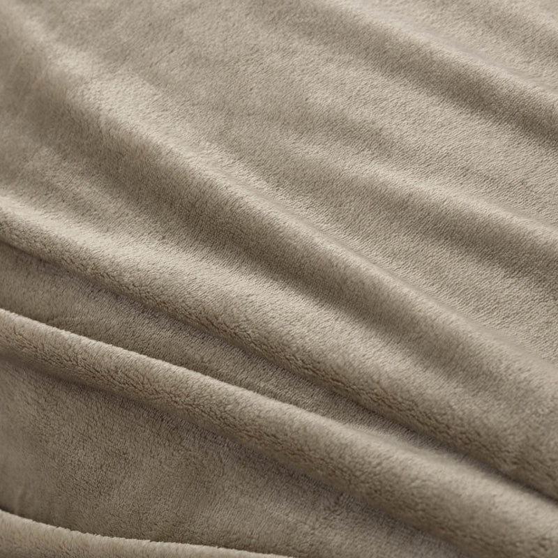 A close-up of a green velvet blanket showing its soft, smooth texture.