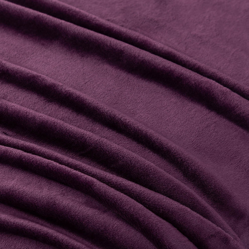 A close-up of a plum velvet blanket showing its smooth texture.