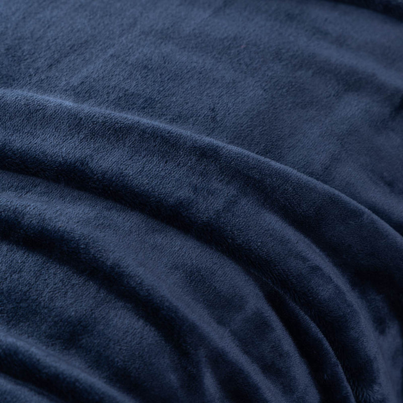 A close-up of a dark blue velvet blanket showing its soft, smooth texture.