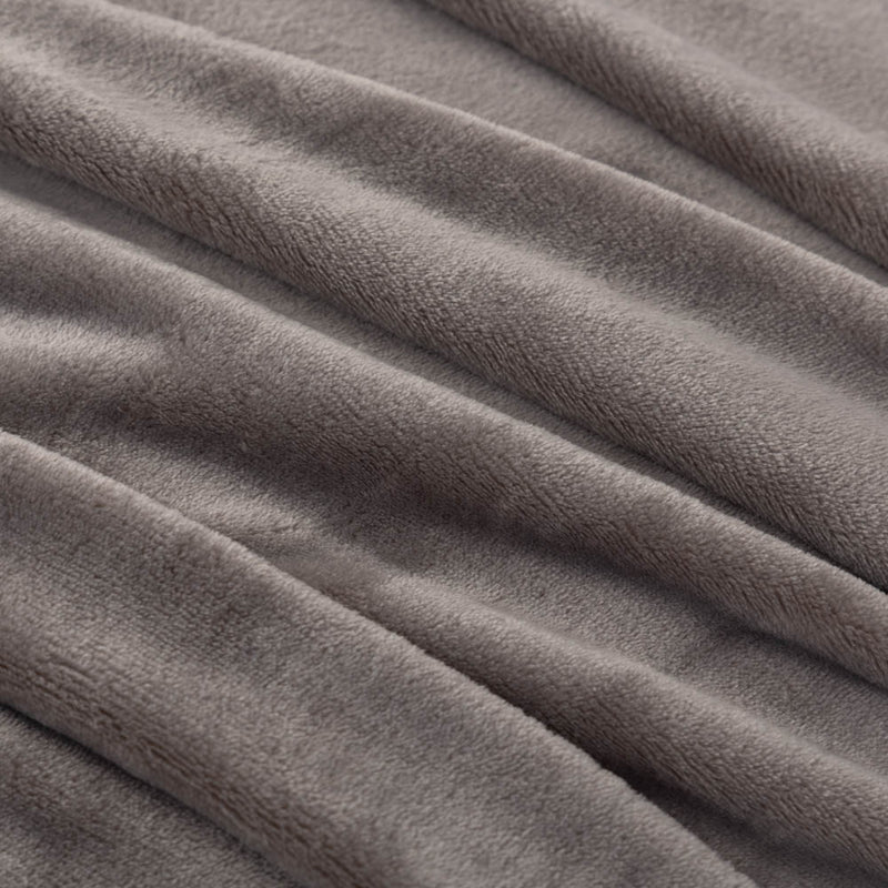 A close-up of a gray velvet blanket showing its soft, smooth texture.