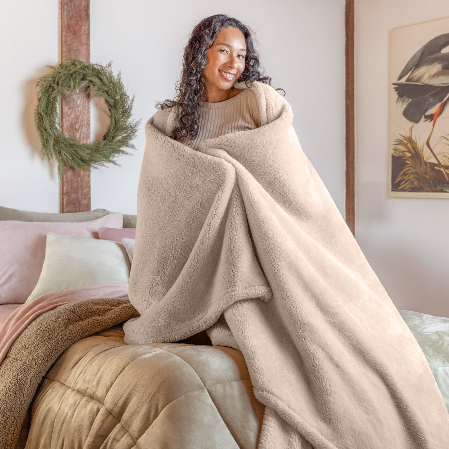 A woman wrapped in a beige extra fluffy blanket.