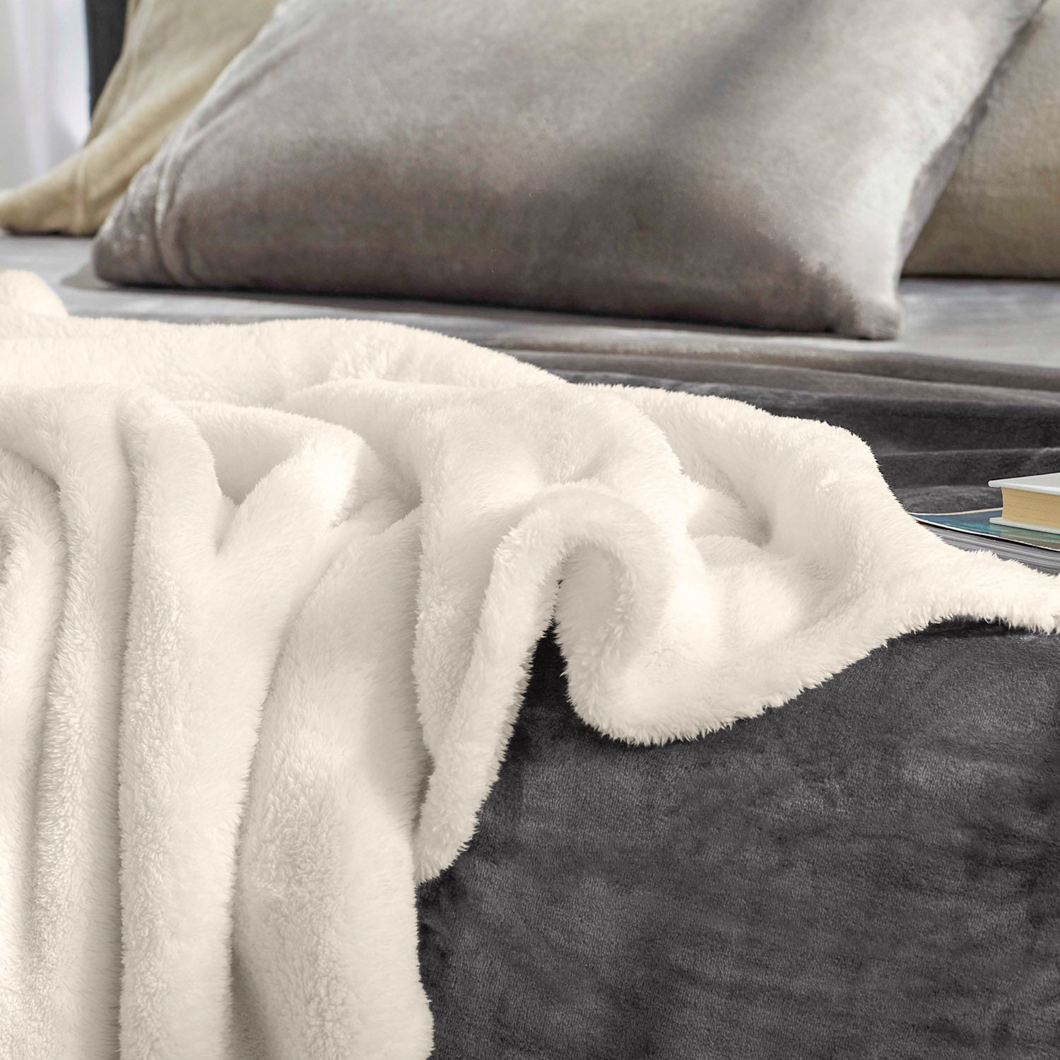 A white fluffy bed blanket laid on a bed.