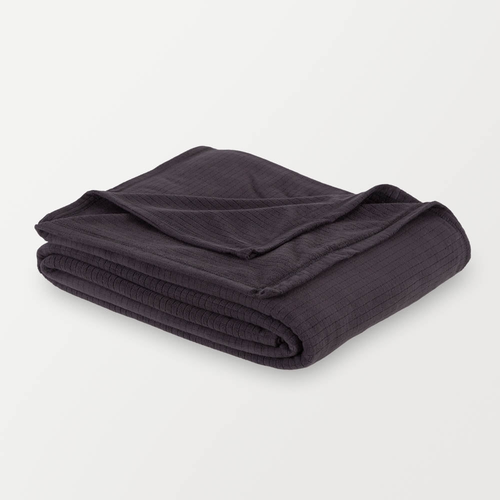 Folded black Polartec Softec Microfleece blanket on a white background.