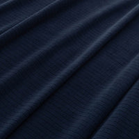 Close-up of the soft microfleece texture of the Polartec blanket in navy.