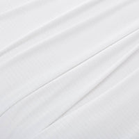 Close-up of the microfleece material of the blanket in white, highlighting its soft texture.