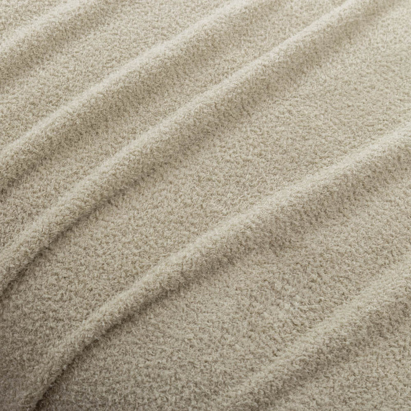 A close-up texture shot of the cream Retro Comfort Plush Blanket in green, showcasing its soft, plush fabric.