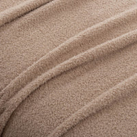 A close-up of the texture of the tan Retro Comfort Plush Blanket, highlighting its plush softness.