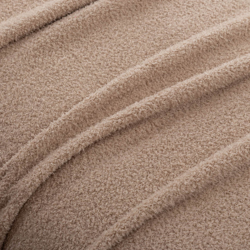 A close-up of the texture of the tan Retro Comfort Plush Blanket, highlighting its plush softness.