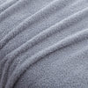 A close-up texture shot of the blue Retro Comfort Plush Blanket, showcasing its plush, soft fabric.