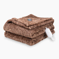 A heathered brown heated Faux Fur Throw folded neatly on a white surface.