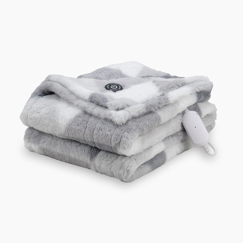 A grey diamond printed heated Faux Fur Throw folded neatly on a white surface.