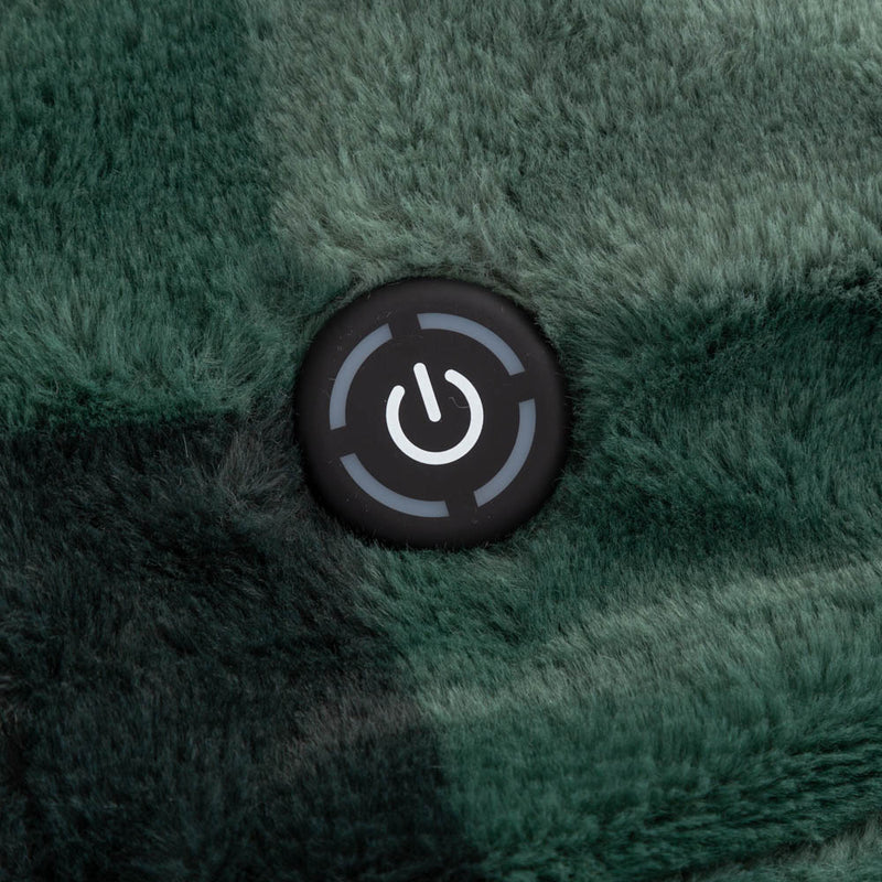 A close up of a dark green heated throw with a power button displayed on its surface.