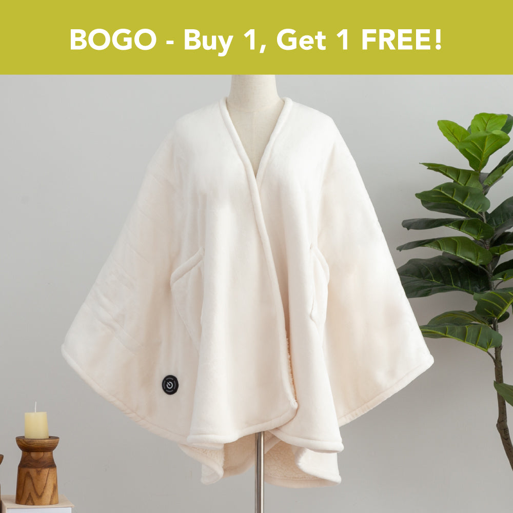 BOGO - Buy 1, Get 1 FREE banner above a cream Heated VelvetLoft Wearable Throw dressed on a mannequin with a plant nd candles in a minimalist room.