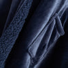 Detailed view of the dark plush interior of the navy heated wearable throw.