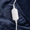 Close-up of the white power cord resting on the navy heated wearable throw.