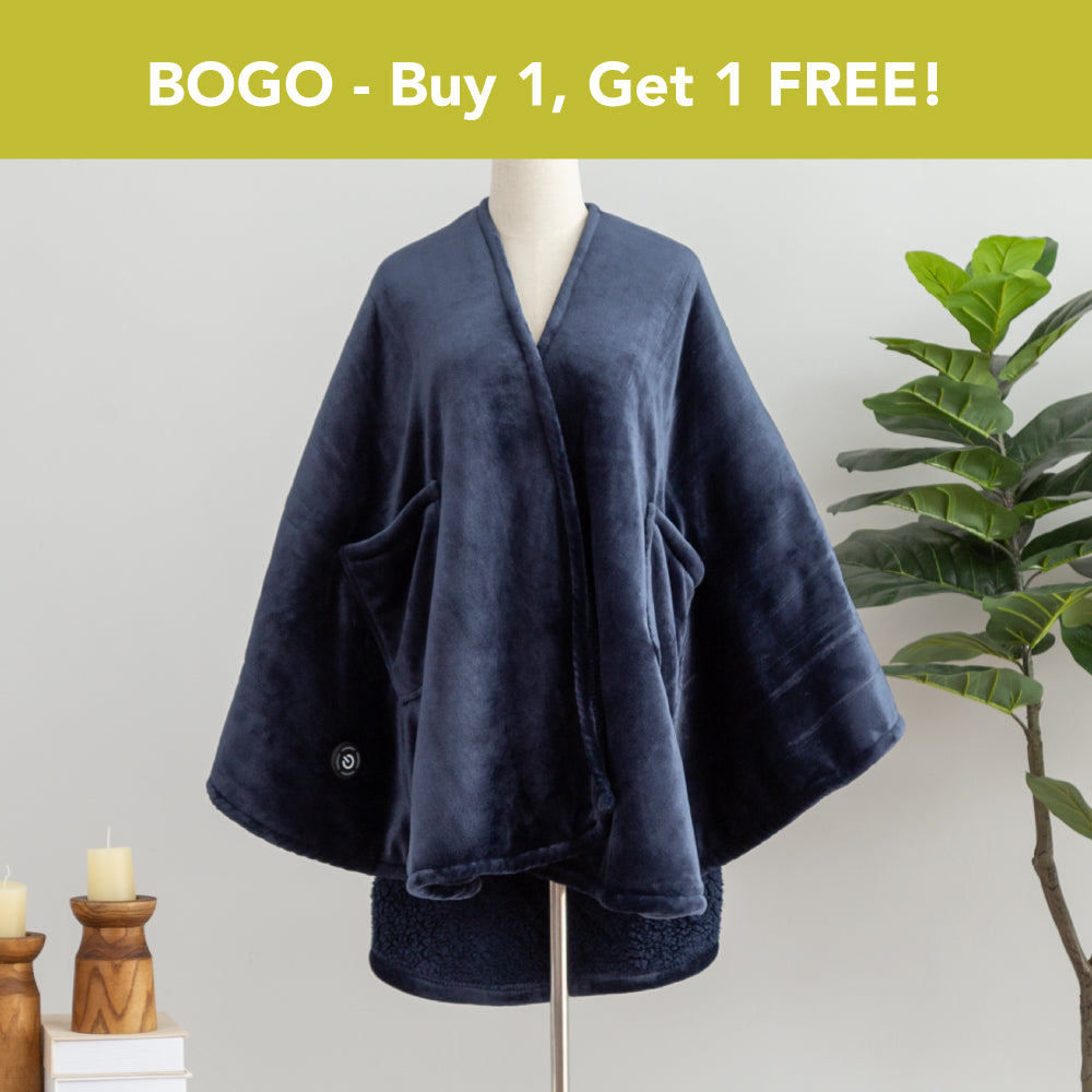 BOGO - Buy 1, Get 1 FREE banner above a navy Heated VelvetLoft Wearable Throw dressed on a mannequin with a plant nd candles in a minimalist room.