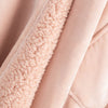 Detailed view of the plush pink fabric texture on the pink heated wearable throw.