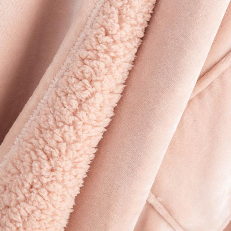 Detailed view of the plush pink fabric texture on the pink heated wearable throw.