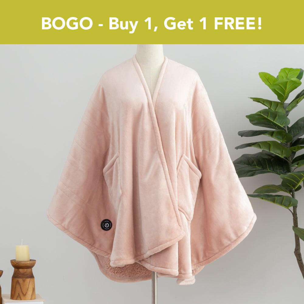 BOGO - Buy 1, Get 1 FREE banner above a pink Heated VelvetLoft Wearable Throw dressed on a mannequin with a plant nd candles in a minimalist room.