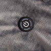 Close-up of the power button on the gray heated wearable throw.