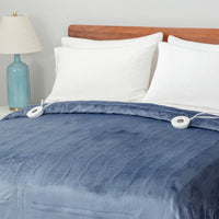 A neatly made bed with a blue heated blanket covering it, topped with white pillows.