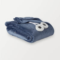 A folded blue heated blanket with two round controllers placed on it.