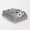 A folded gray heated blanket with two round controllers placed on it.