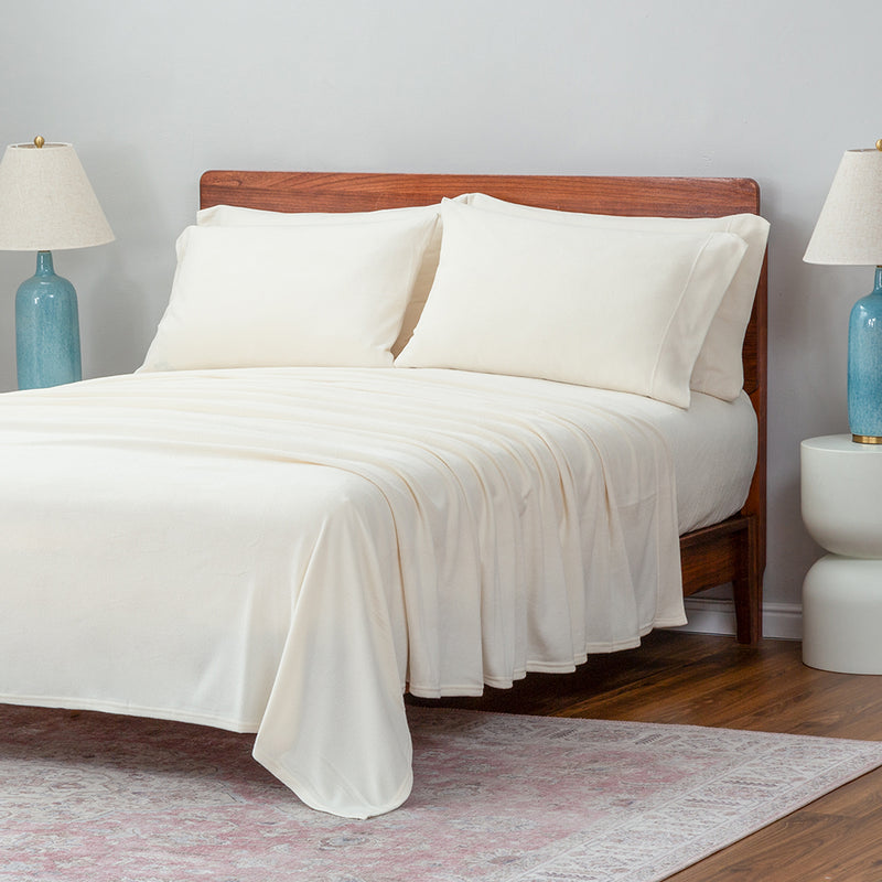 Warm ivory pillowcases displayed on a bed in a bedroom setting.