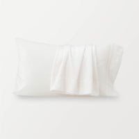 White pillowcases displayed on a white surface.