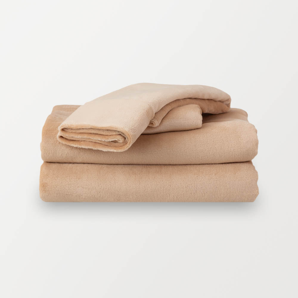 Folded Aruba Sand (beige color) sheet set on a clean, white background.
