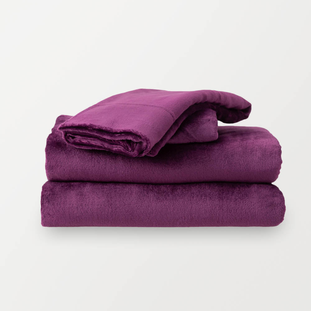 Folded Eggplant sheet set on a white background.