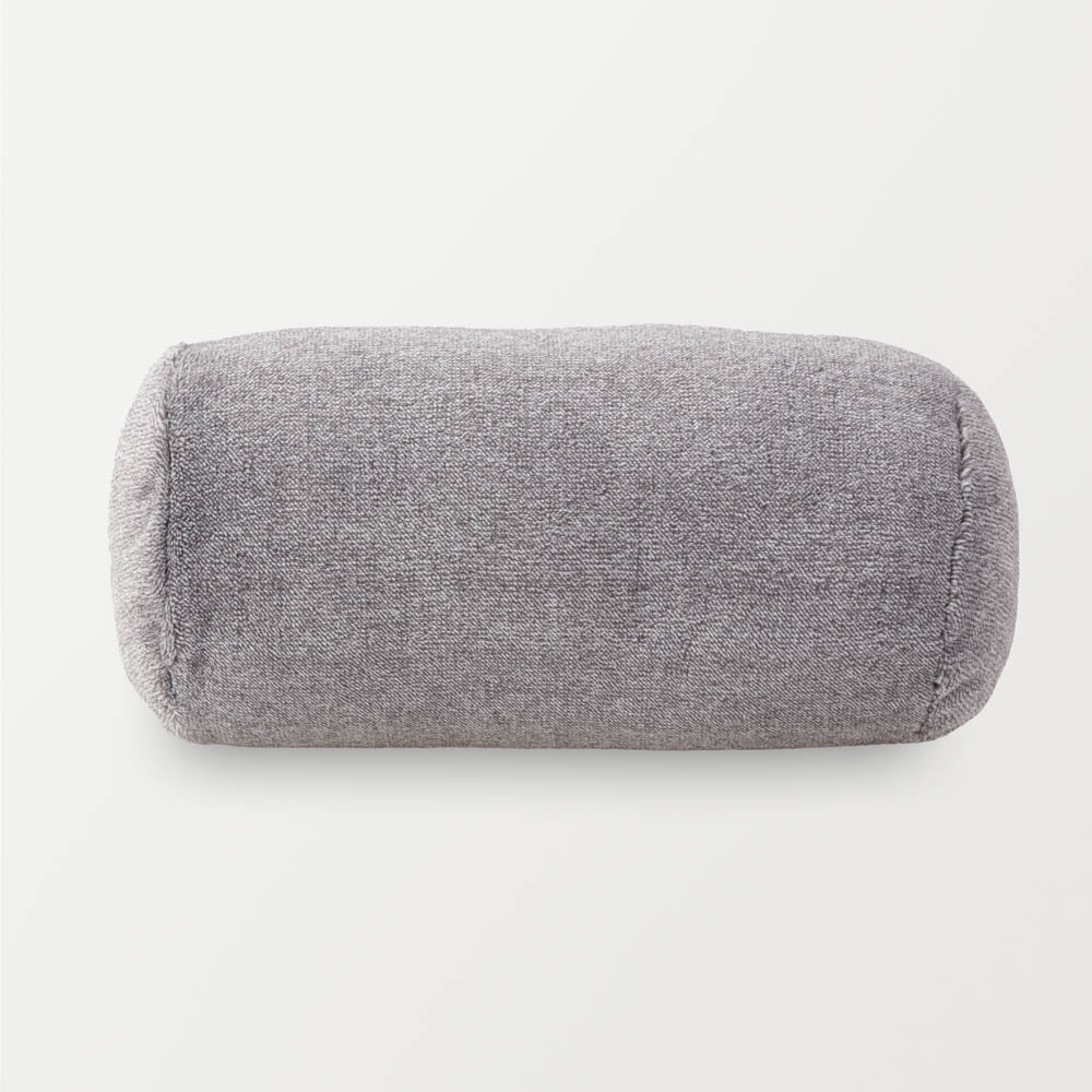 A grey EcoThread Neckroll Pillow on a white surface.