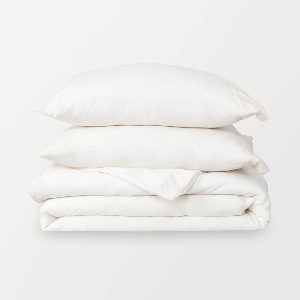 VelvetLoft® Plush Duvet Cover Set in Cream, neatly folded with two matching pillow shams stacked on top.