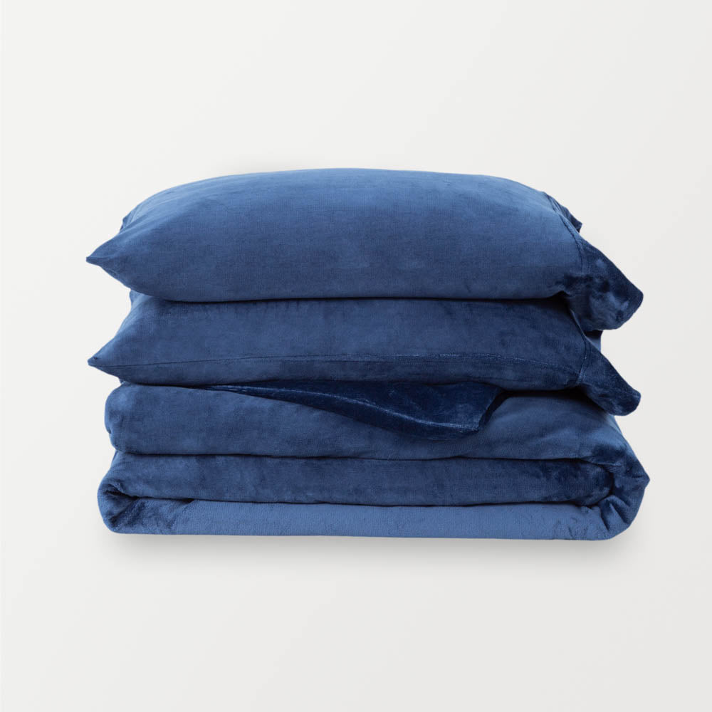 VelvetLoft® Plush Duvet Cover Set in Dress Blue, neatly folded with two matching pillow shams stacked on top.