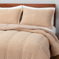 A bed made with a the Retro Comfort Plush comforter set  including matching pillow shams in almond seed. 