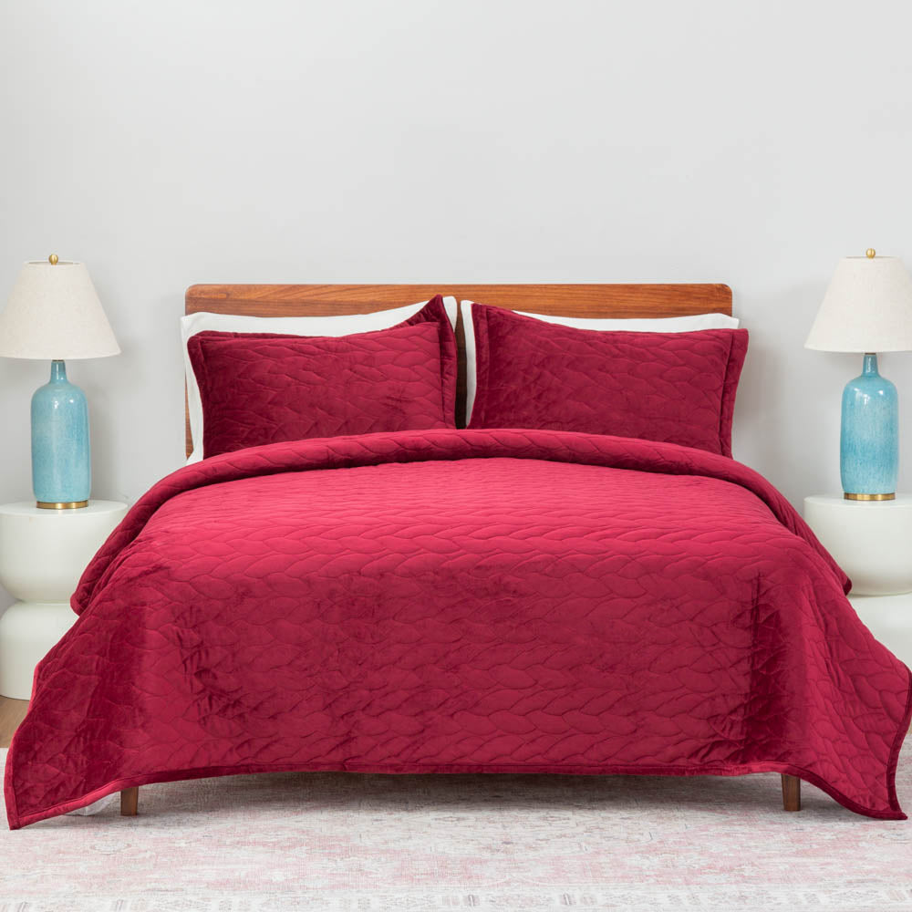 A bed made with the Windsor Wine VelvetLoft® Quilt Set, showcasing a clean and crisp bedding arrangement.