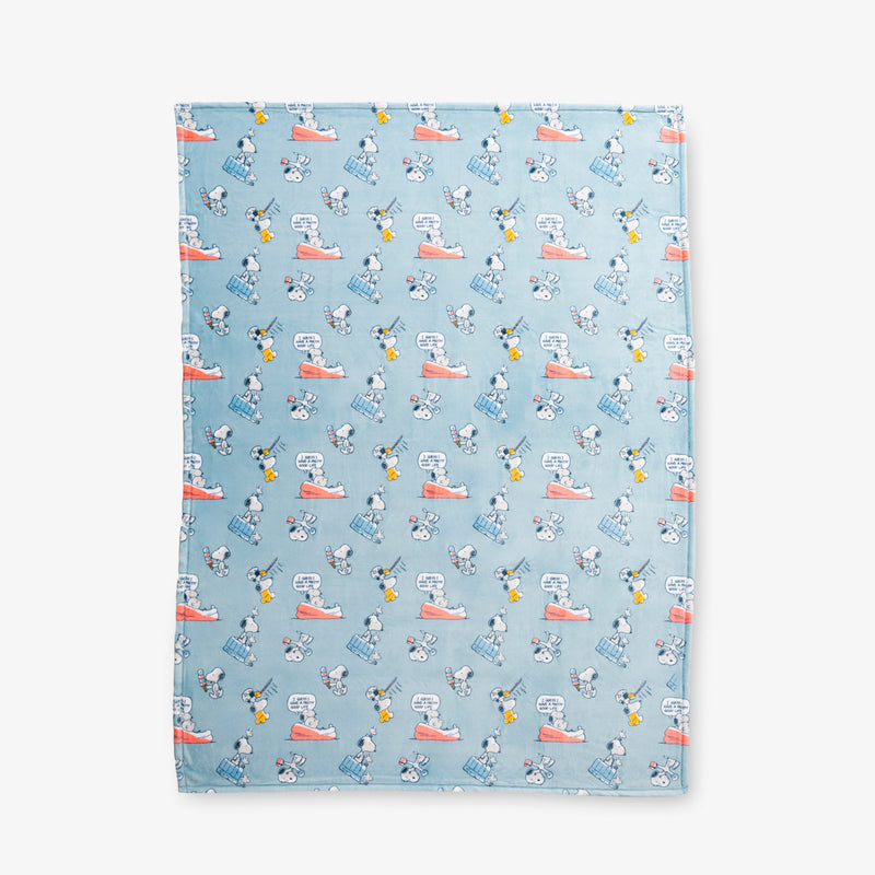 Blue Peanuts 75th Anniversary Throw laid flat on a white surface.