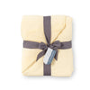 Yellow VelvetLoft Gauze Throw folded neatly on a white surface.