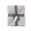 Grey VelvetLoft Gauze Throw folded neatly on a white surface.