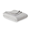 Grey VelvetLoft Gauze Throw folded neatly on a white surface.