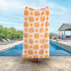 Vicky Yorke Summer Nostalgia beach towel held up by a person standing by a pool.