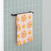 Vicky Yorke Summer Nostalgia beach draped neatly over a metal towel rod.