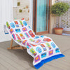 Bex Morley Sardine Tin beach towel draped neatly over a wooden lounge chair on a patio.