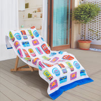 Bex Morley Sardine Tin beach towel draped neatly over a wooden lounge chair on a patio.