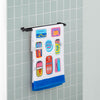 Bex Morley Sardine Tin beach towel draped neatly over a metal towel rod in a bathroom.