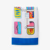 Bex Morley Sardine Tin beach towel folded neatly on a white surface.