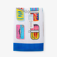 Bex Morley Sardine Tin beach towel folded neatly on a white surface.